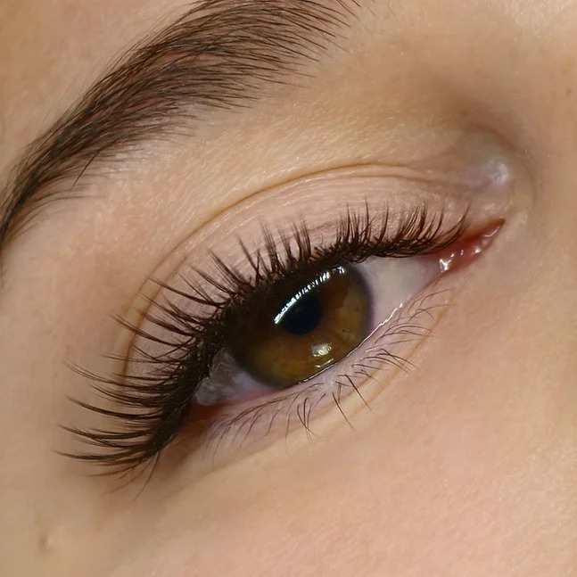 Close-up of a hazel eye with soft, wispy angel lash extensions